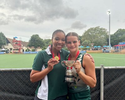 Durban Girls' College coach Chardinay Penniston and captain Emily Macquet hold aloft the St Mary's Hockey Festival winners' trophy.