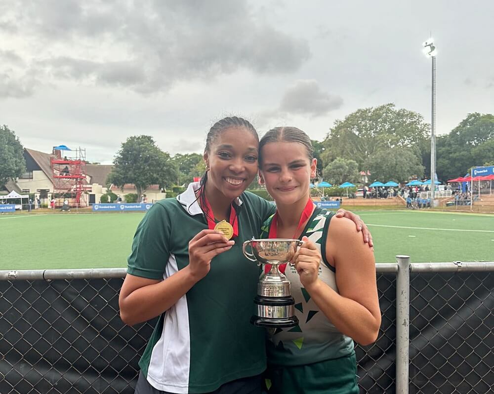 Durban Girls' College coach Chardinay Penniston and captain Emily Macquet hold aloft the St Mary's Hockey Festival winners' trophy.