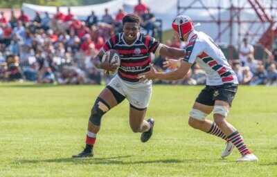 Maritzburg College defender Nkululeko Sithole hands off a defender before bursting through to score Maritzburg College's second try. Photo: Justin Waldman Sports Photography.