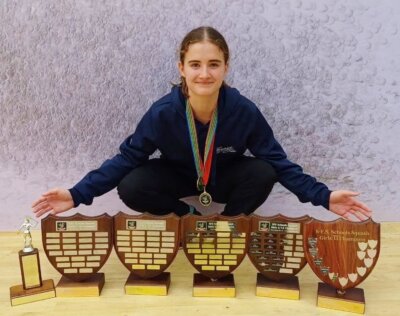 Bianca Rees-Gibbs shows off the collection of trophies she has won in different age groups in the Southern Free State Closed Squash Championships.