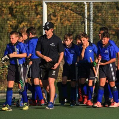 A young Reuben Sendzul in picture next to his u13 coach at Bridge House. Photo credits: Supplied