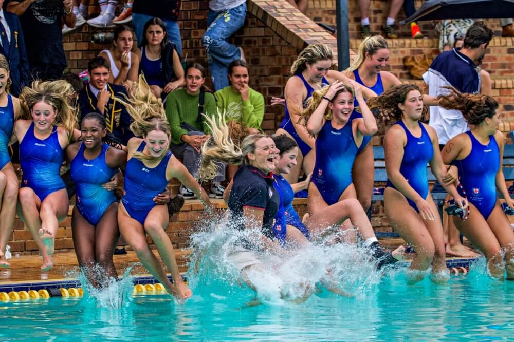 Coach Megan Sileno and her St Stithians team celebrates winning the Reef Cup with the traditional plunge into the pool. Photo: Debbi Adcock Photography.