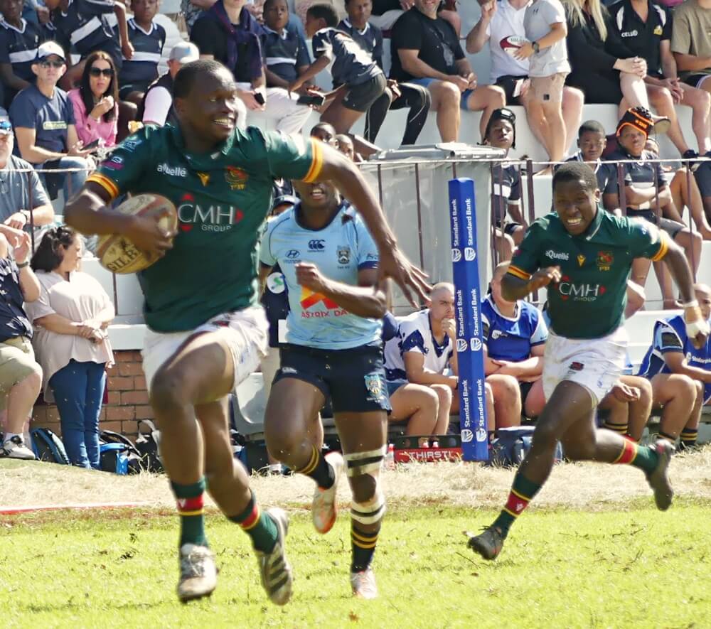 With a smile on his face after intercepting a pass, Glenwood captain Lizwe Mtetwa charges away from Milnerton's defenders, on his way to a try for the Green Machine. Photo: Brad Morgan.
