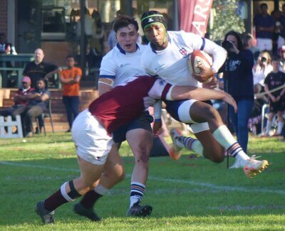 St Stithians' fullback Omphile Maphira goes airborne as he is hit in a tackle. Photo: Brad Morgan.