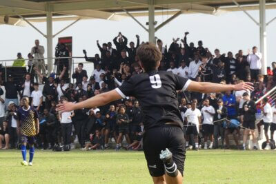 Hilton College striker Efe Ozcan races towards the crowd to celebrate scoring the opening goal in the final of the Primo Big 10. Photo: Brad Morgan.