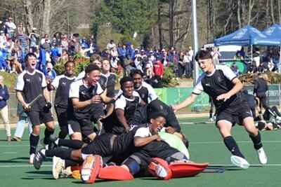 The KZN Coastal A players jump on top of their penalty shootout heroes, Tye Milne and Georg Wolhuter, to celebrate a sensational comeback victory. Photo: Brad Morgan.