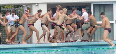 Clifton takes the winners' traditional celebratory swim after winning the U19 title. Photo: Brad Morgan.
